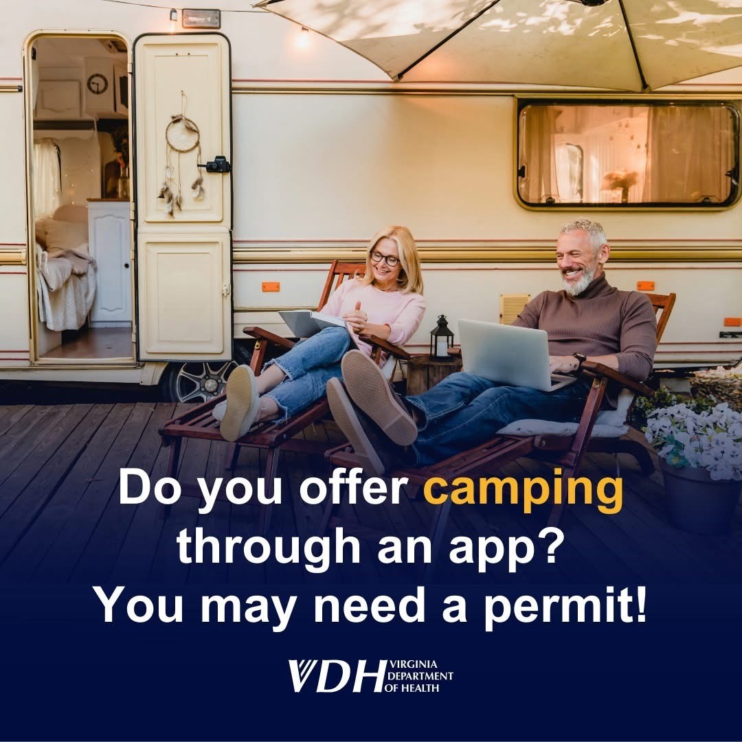 Image of couple looking at laptops next to a RV